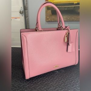 Coach purse. Cross body strap. Rose in color. Brand new. Lots of pockets. NWT